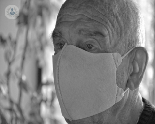 An older man wearing a face mask