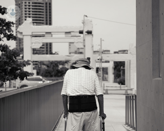 an older man with a walking stick 