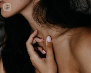 woman touching neck