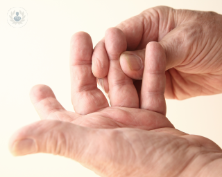 Pair of hands checking joints for signs of psoriatic arthritis