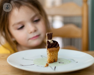 Child looking at a cupcake
