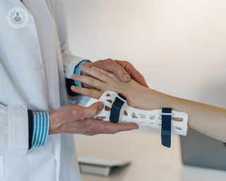 Close up of medical professional placing a wrist splint onto a patient.