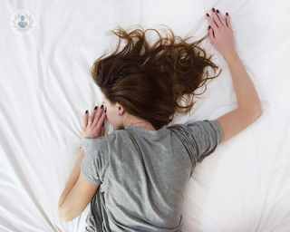 girl lying on a bed face down