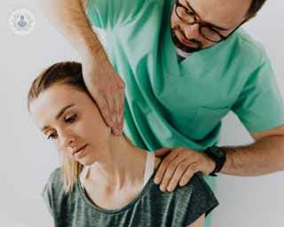 Woman receiving a musculoskeletal assessment on her neck