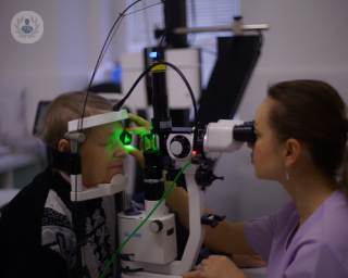 A picture of a woman examining someone's eyes