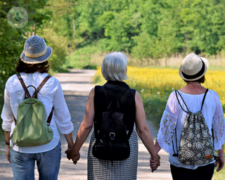 Three women walking and holding hands