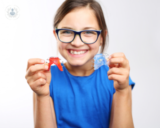 Child with braces smiling 