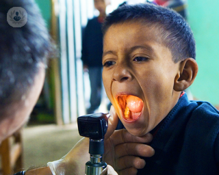 Child having tonsils examined