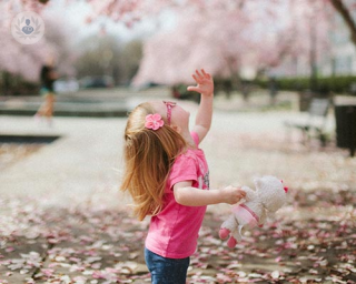 Child among cherry blossoms 