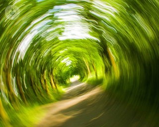 A blurry image of trees to represent dizziness