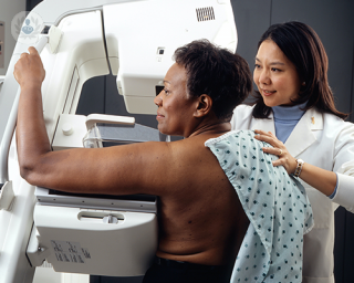 A women undergoing a mammogram, which is an X-ray picture of the breast