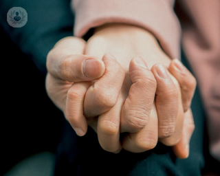Close up shot of couple holding hands