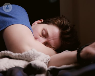 Man sleeping wearing a blue t-shirt