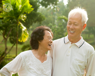 An elderly couple laughing.