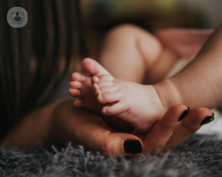 Woman holding baby's feet
