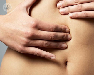 What causes an abdominal wall hernia?