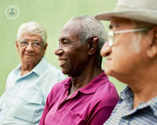 Three older men sit together. Men over a certain age are at a higher risk of developing prostate cancer. Radical prostatectomy is an option to treat this.