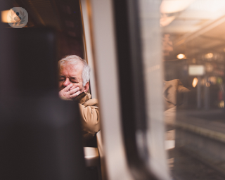 Tired elderly man on a train