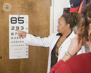 A patient undergoing a visual acuity test at the ophthalmologist's office.