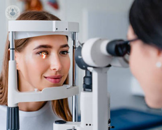 an optician checking a patient's eye