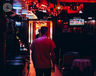 man walking through a bar