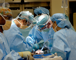 Surgeons standing around a patient during surgery