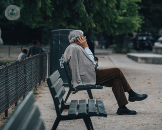An old man sitting on a bench