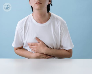 A boy clutching his stomach in pain
