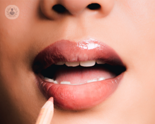 A close up picture of a woman with glossy lips 