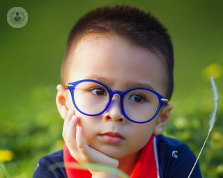 A picture of a young boy wearing glasses