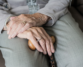 An elderly person's hands.