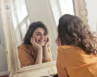 a girl smiling in the mirror