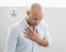 Man with chest pain holding his chest