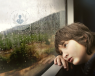 Boy with ADHD looking out of a train window
