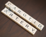 Scrabble pieces spelling out 'carotid artery'