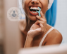 Woman looking in the mirror flossing