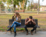 Man and woman upset sat on a bench outside