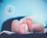 A baby in a nappy lies on the changing table, with its feet facing the camera. Children and infants are at risk from having urinary tract infections.