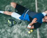 cute man lying on tennis court floor 