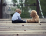 An image of a child and a bear on a bridge