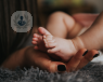 Woman holding baby's feet