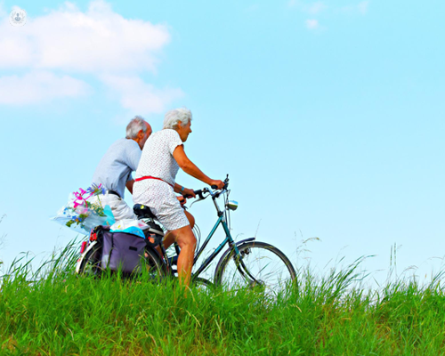 A healthy older couple cycling outside - exercise is a good way to avoid having cardiac arrest