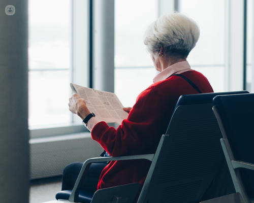 Older woman sat on airport seat