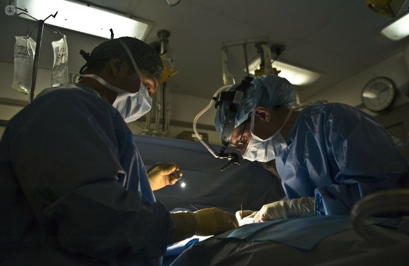A surgeon performs a phalloplasty procedure on a patient undergoing gender confirmation.