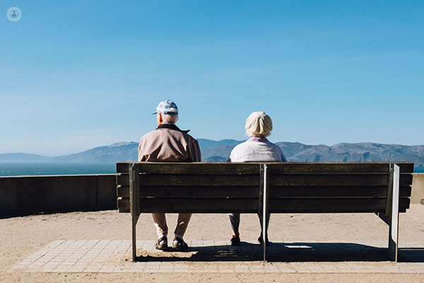Elderly couple sitting together on a bench
