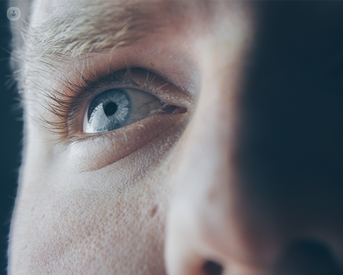 A man's blue eye and the surrounding area