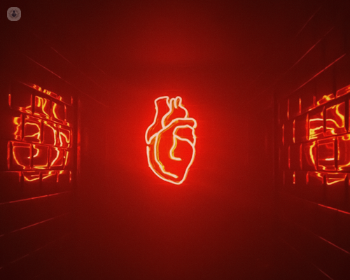 Neon red heart in a dark room, reflecting off the shiny walls