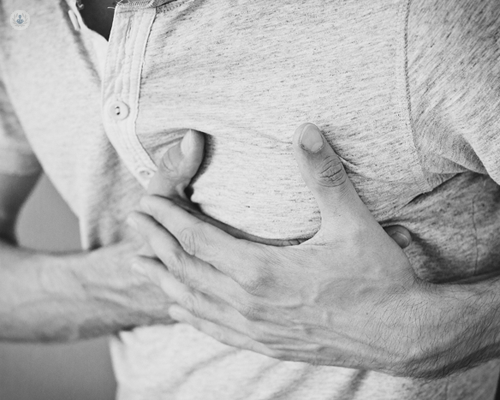 Man with angina holding his chest