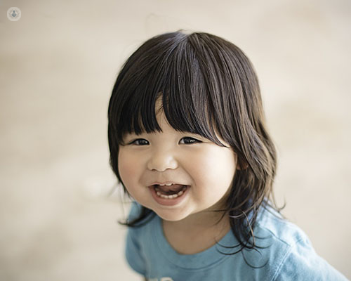 Young child smiling. Macroglossia, also known as an enlarged or giant tongue, is a rare disorder that is usually found in children. 