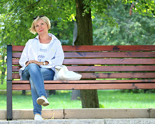 Woman with a fistula, sat on a bench
